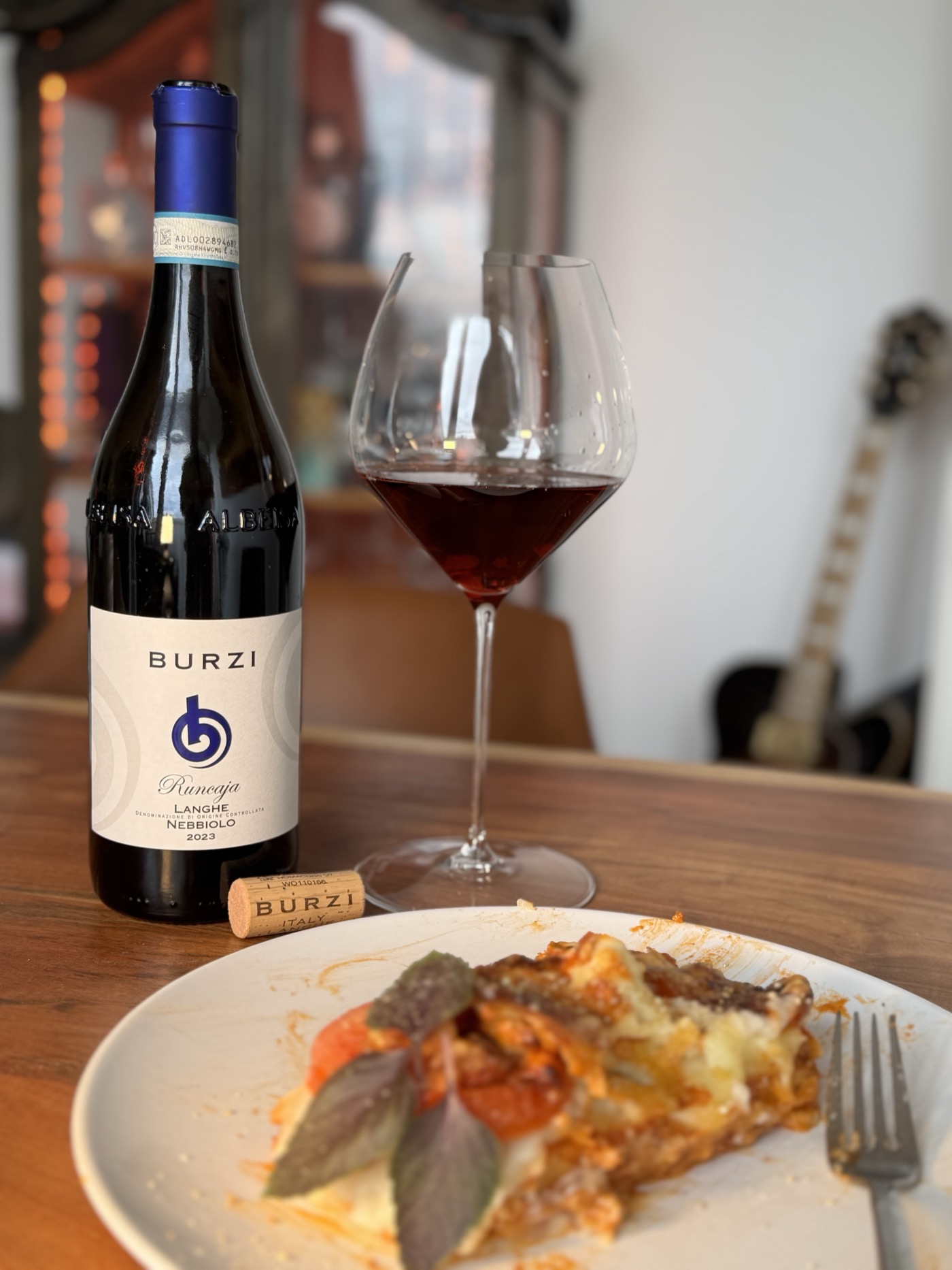 Burzi Ruucaja Langhe Nebbiolo 2022 in a Riedel Pinot Noir / Burgundy glass, paired with sage lasagne