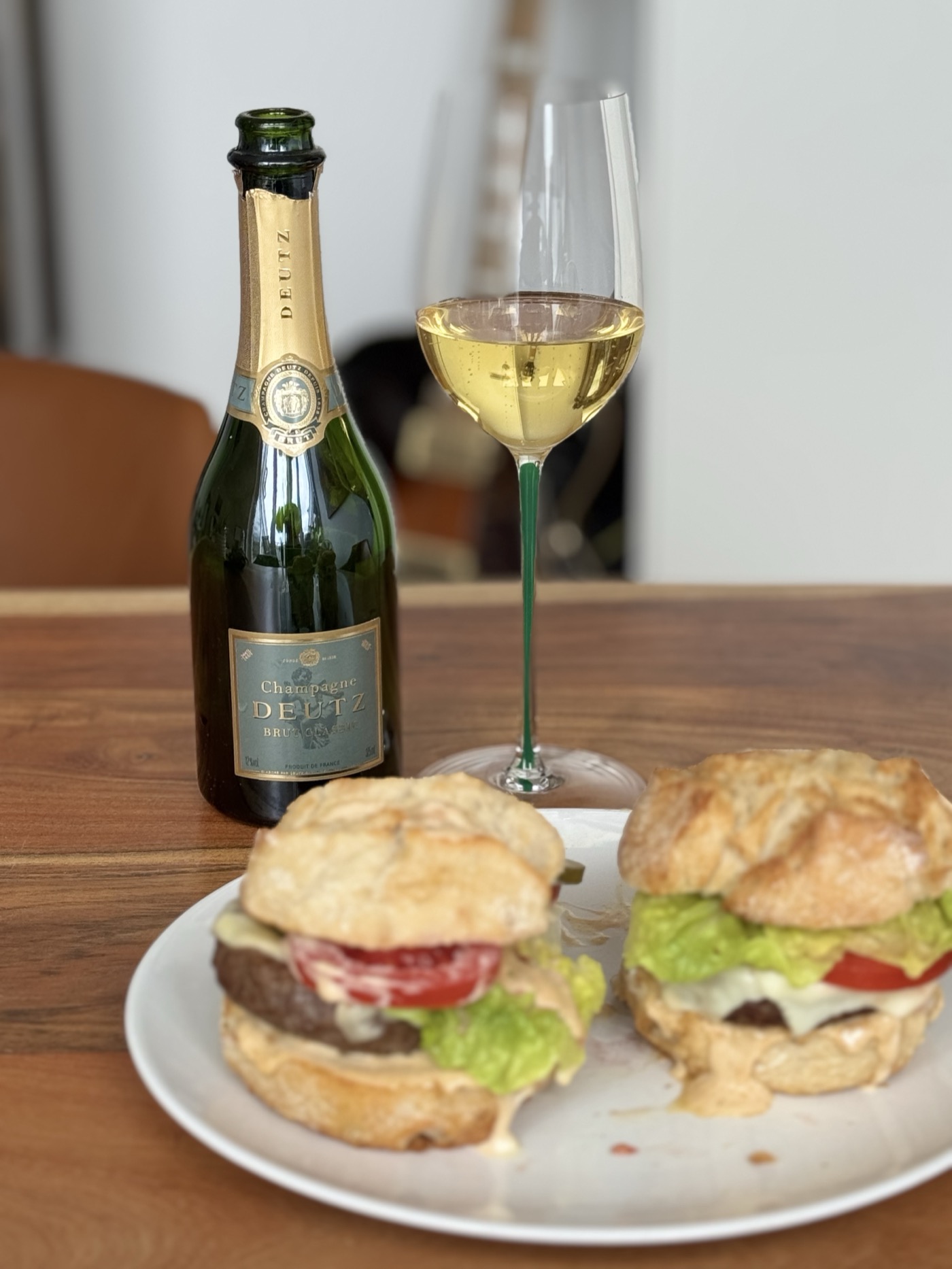 Champagne Deutz Brut Classic half-bottle in a Riedel Fatto a Mano Riesling glass with a hand-painted green stem, paired with two homemade burgers