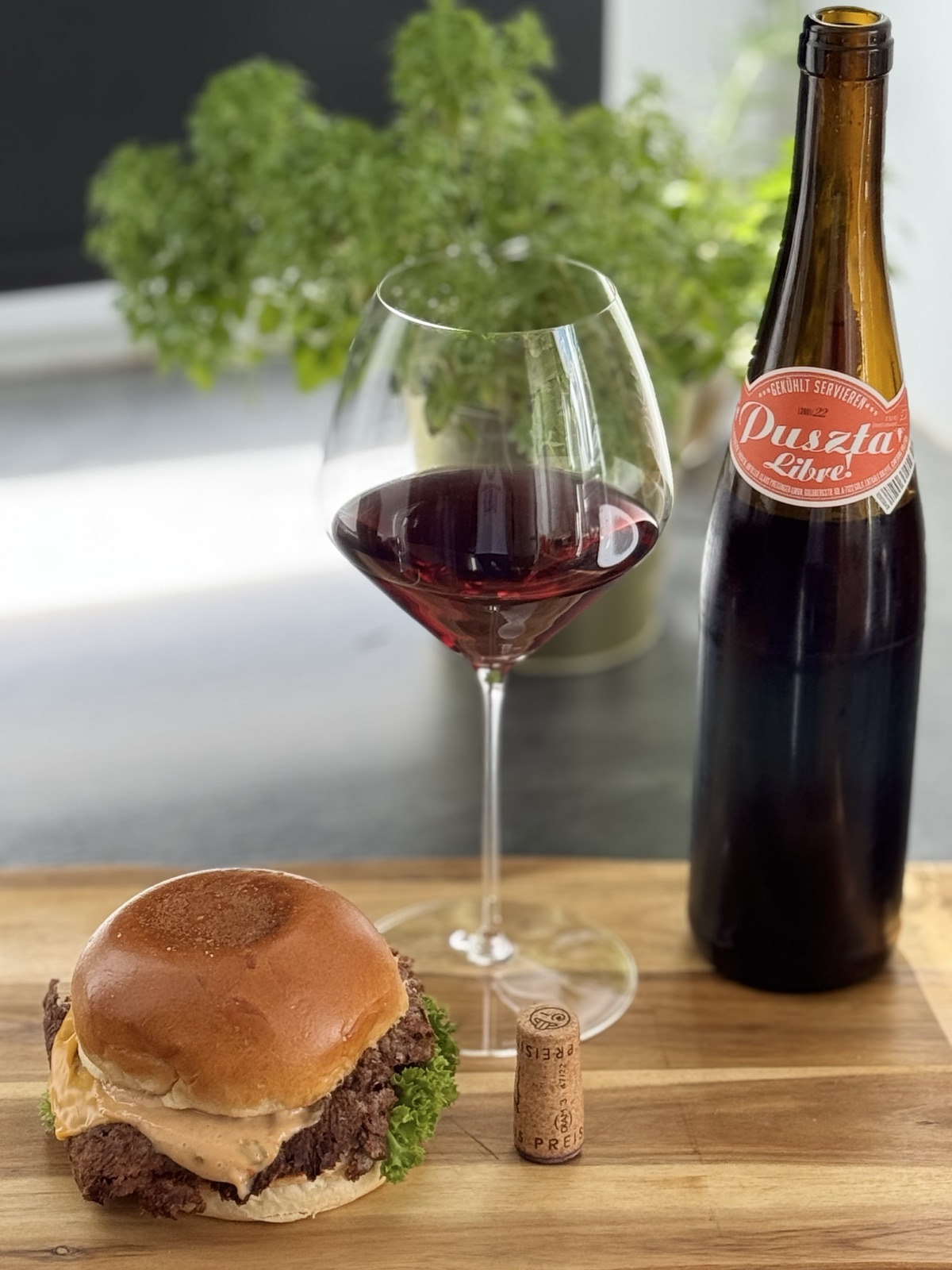 Preisinger Puszta Libre 2022 in a Riedel Veloce Pinot Noir glass, paired with a smashburger