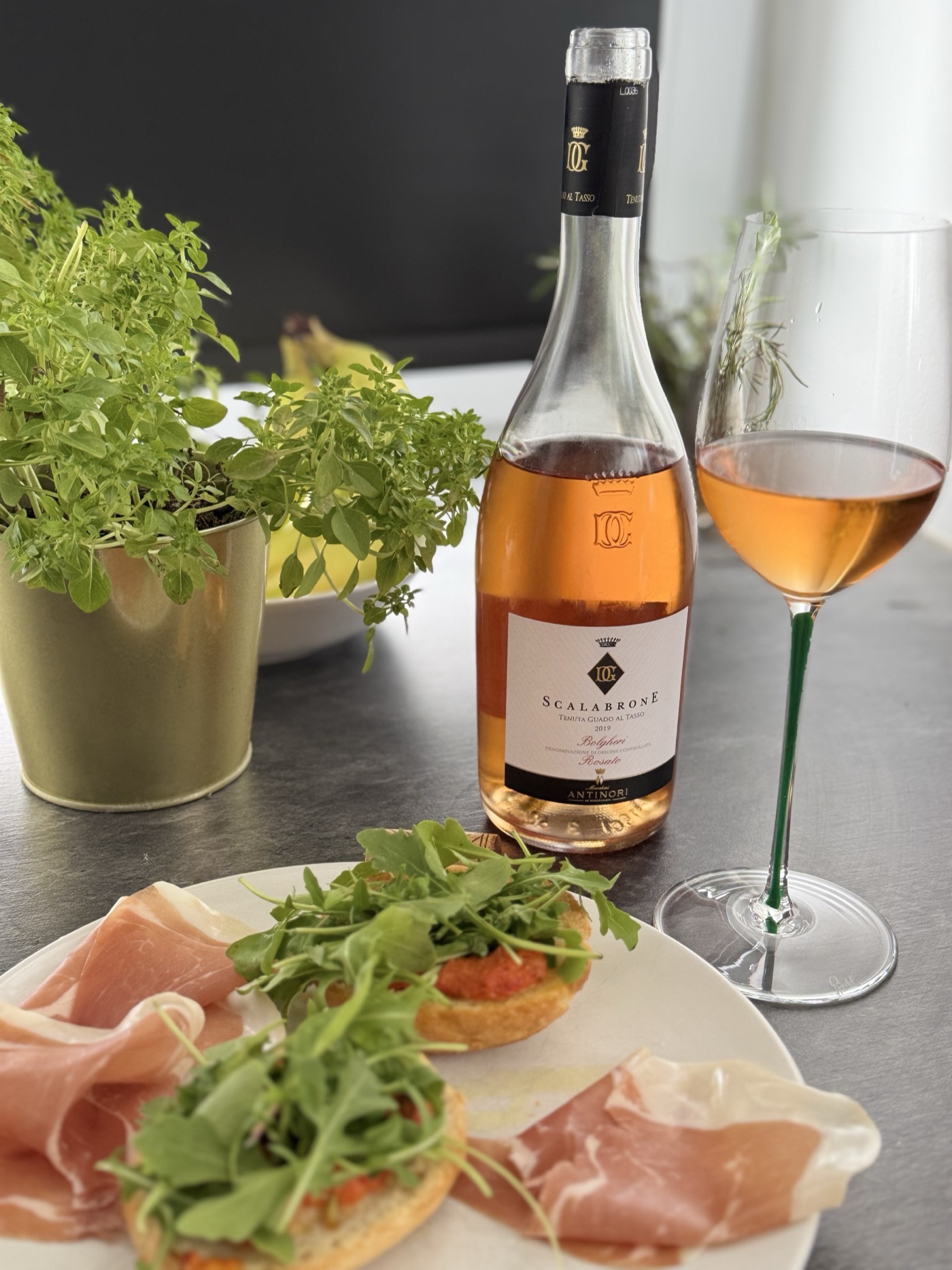 Antinori Scalabrone Bolgheri Rosato 2019 in a Riedel Fatto a Mano Riesling glass with a hand-painted green stem, paired with prosciutto and rocket bruschetta
