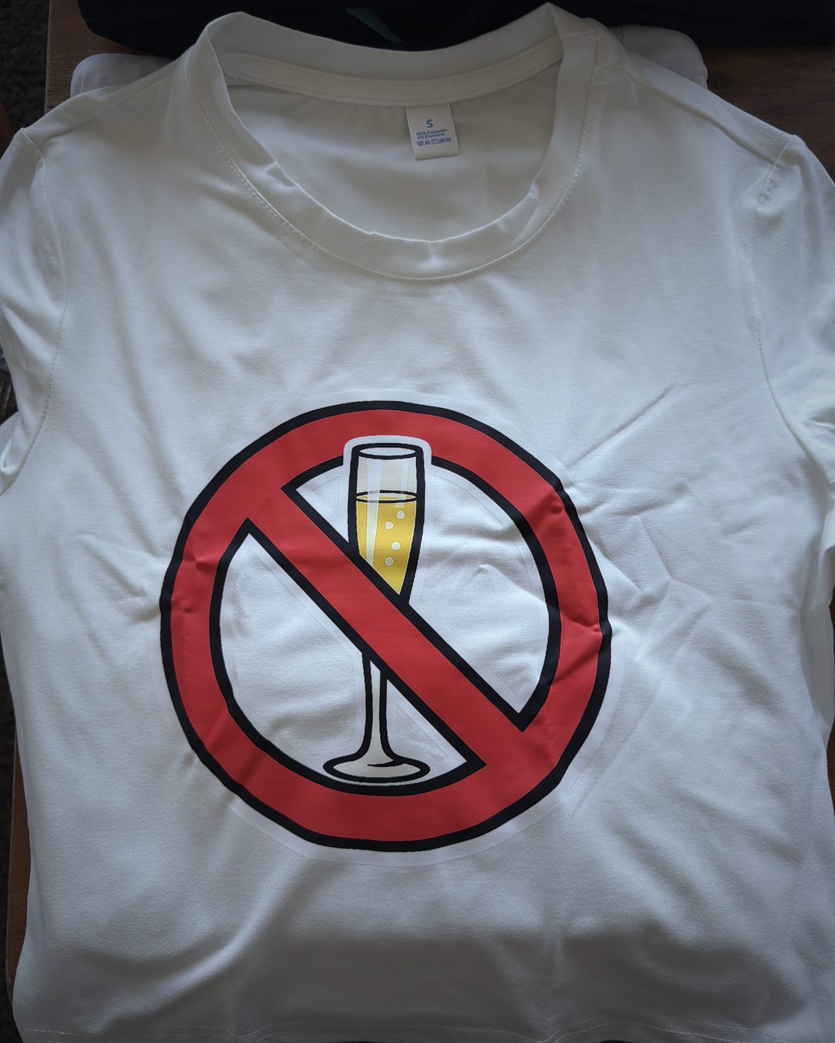 White crop top with a large red no-flute signet centered