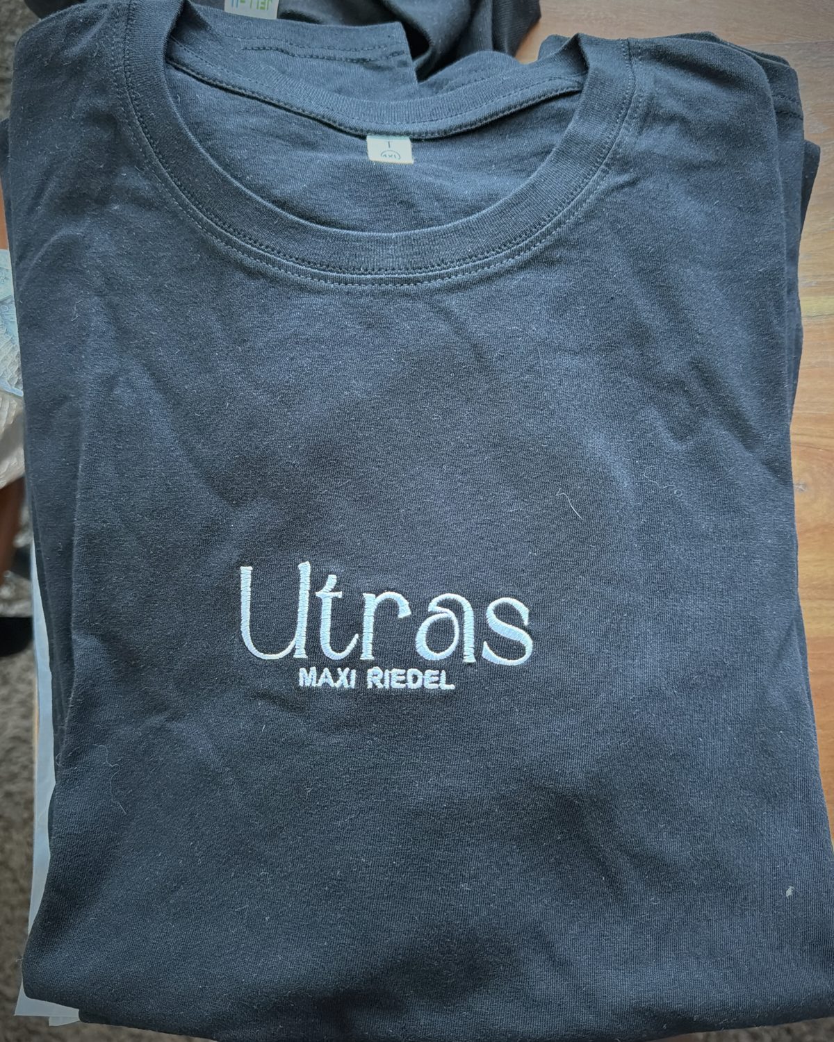 Black T-shirt with Ultras / MAXI RIEDEL embroidered in silver thread